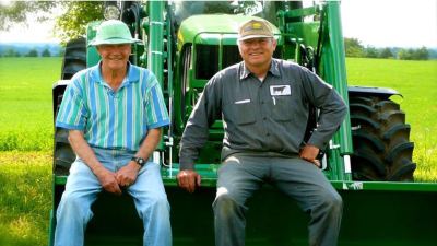 Two men on a tractor. 