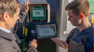 Farmer and nutritionist looking at InTouch controller and app